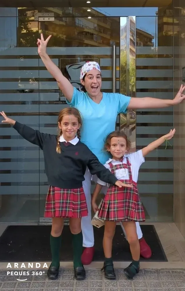 Equipo de Clínica Dental Aranda con niñas en la entrada de la clínica